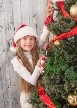 Little Teenage Girl Hanging Multi-coloured Balls On New Year Tree At Home.  Happy Girl In Santa Hat Smiling For Photographer. Stock Photo, Picture And  Royalty Free Image. Image 48860777.
